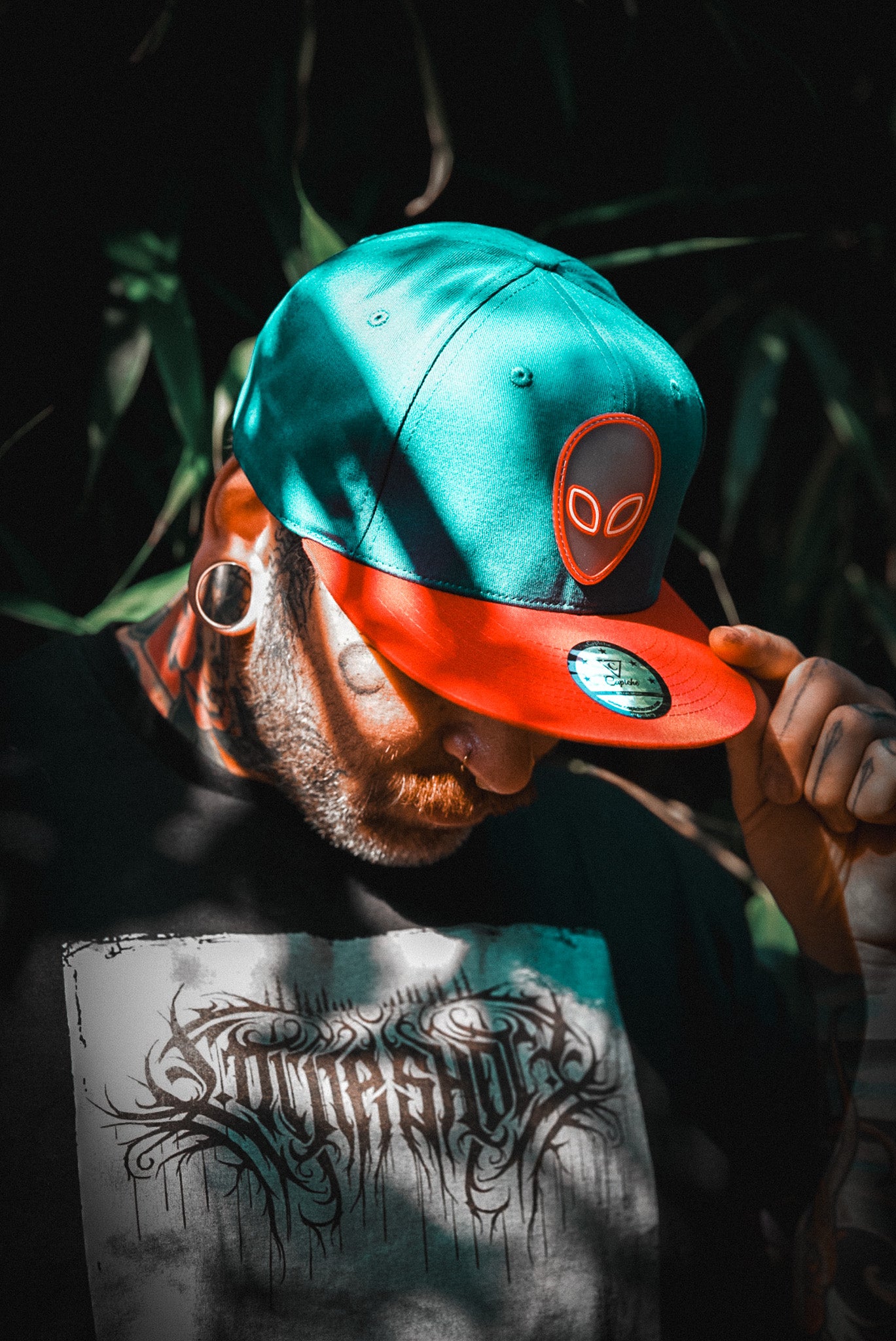 Tattoo Model Wearing Blue Red Snapback with Alien Logo