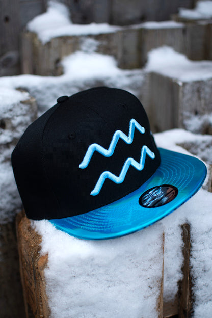 Aquarius Black Snapback Hat with Blue Metallic Brim Zodiac Sign from Capiche Caps