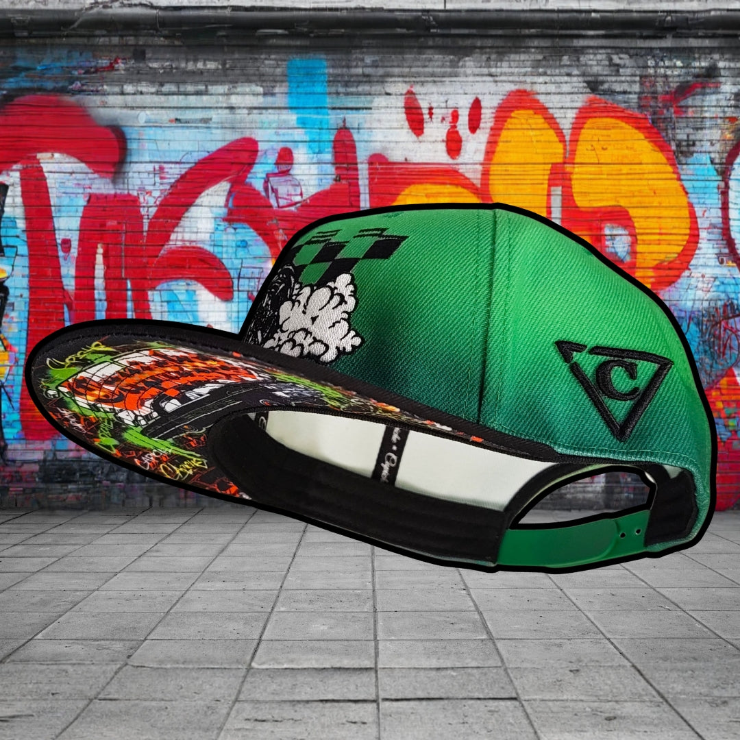 Green cap with colorful design on a graffiti-covered wall background