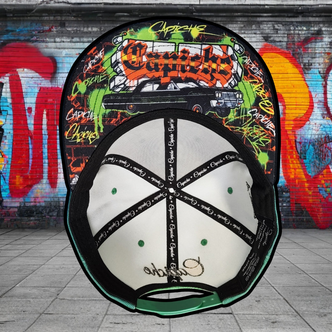 Colorful cap with graphic design against a graffiti-covered wall
