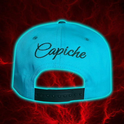 Back view of a blue snapback hat with the company name visible Capiche