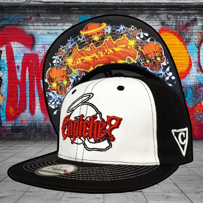 Black and white cap with red logo against a graffiti-covered wall.