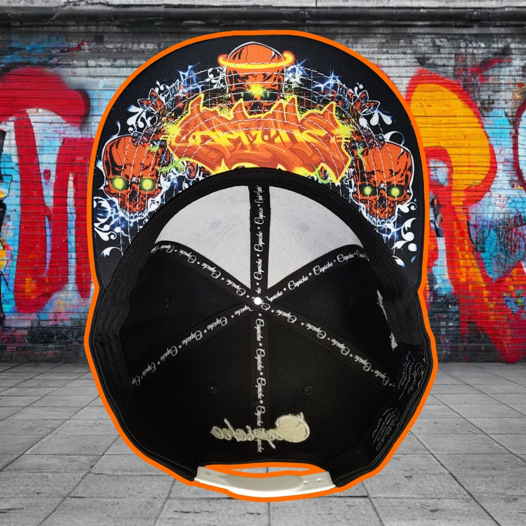 Black cap with colorful designs on a graffiti-covered wall background