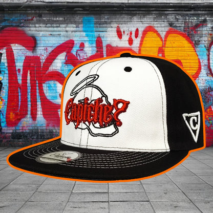 Black and white cap with red logo against a graffiti-covered wall