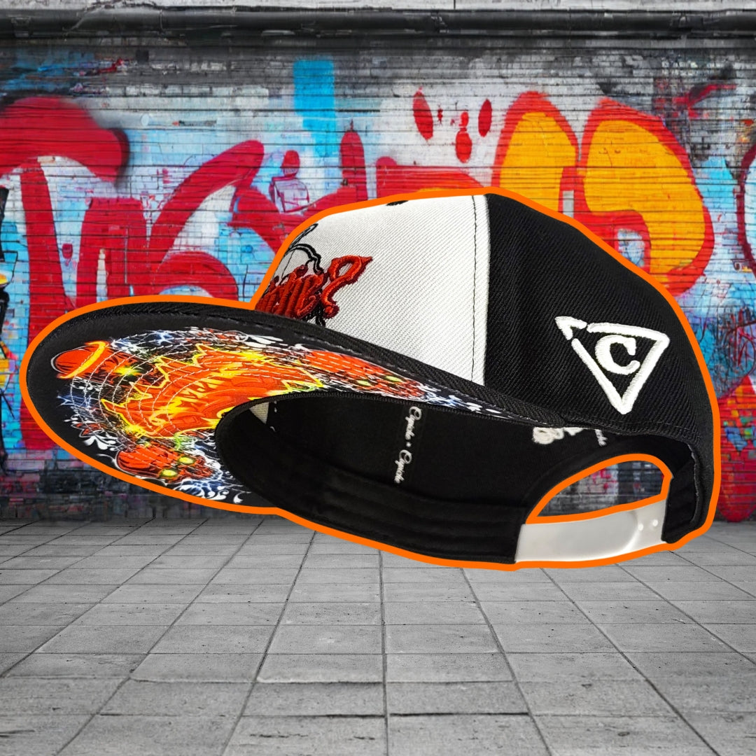 Colorful cap with flame design and brand logo against a graffiti-covered wall.