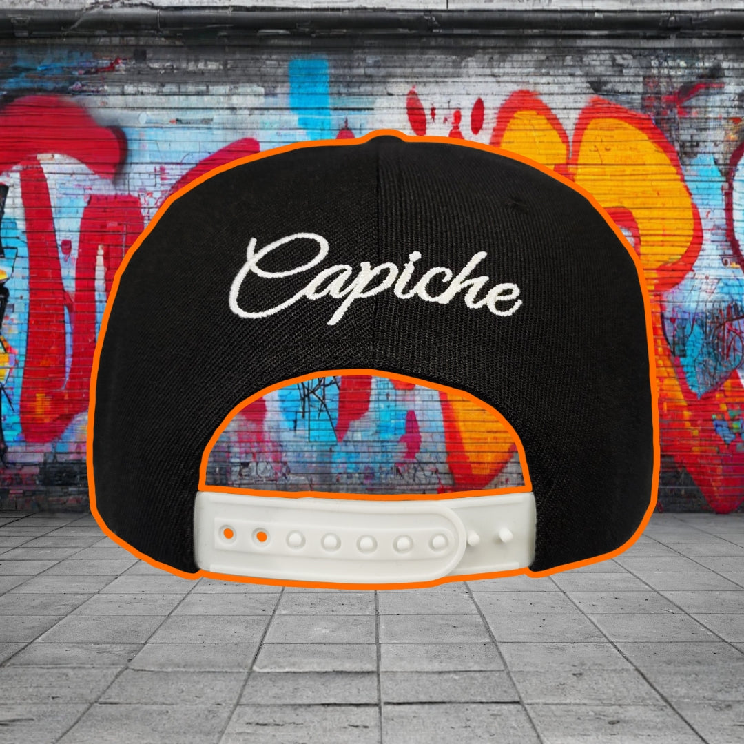 Black cap with 'Capiche' logo against a graffiti-covered wall